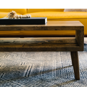 A mid-century influenced coffee table in a deep brown finish, handmade by Kase Custom